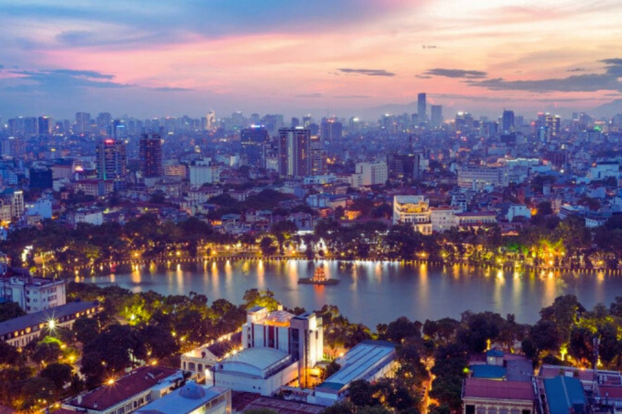Hanoi skyline at sunset with Hoan Kiem Lake lights reflecting – Auasia Travel